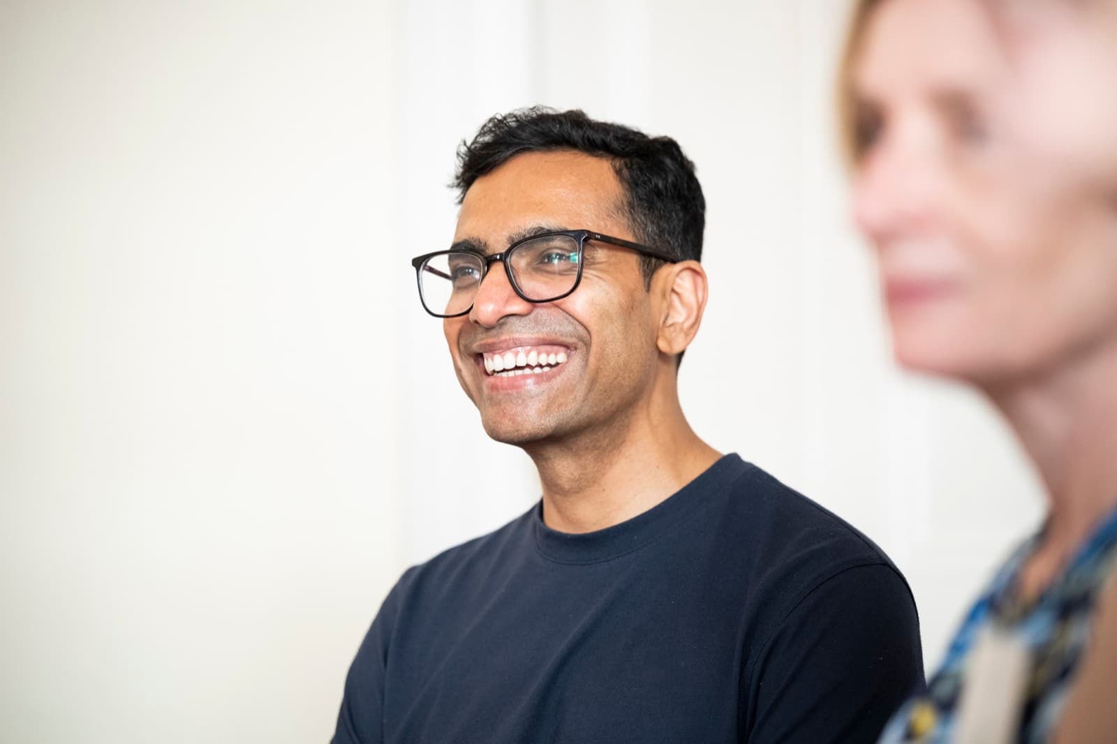 A course participant smiling during discussion.
